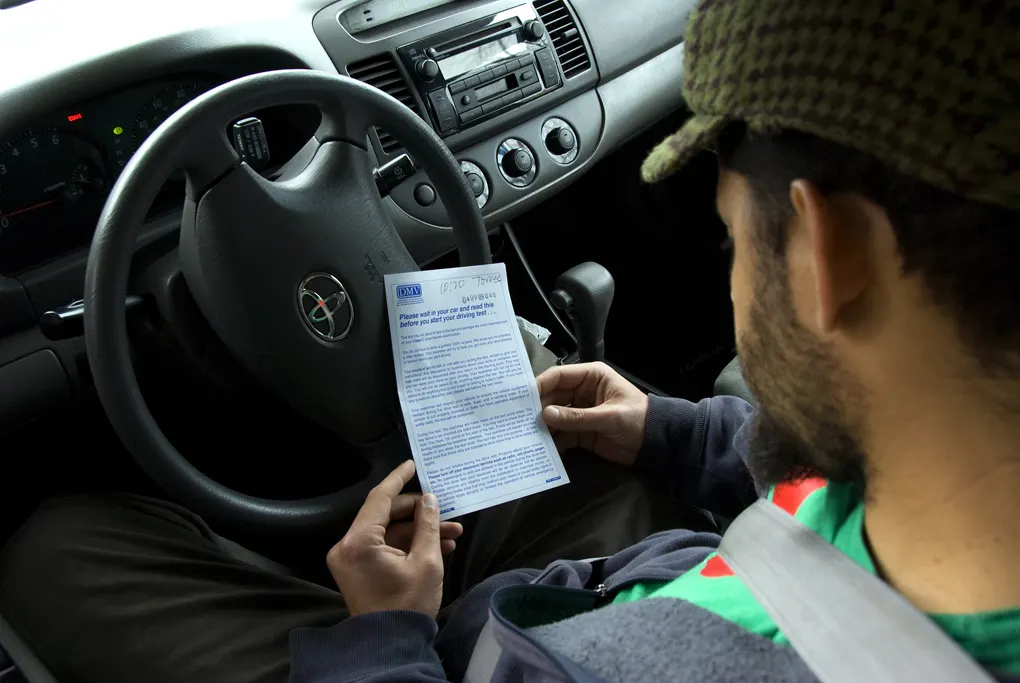 A driver license candidate waiting in a car for a drive test at an Oregon DMV drive test center