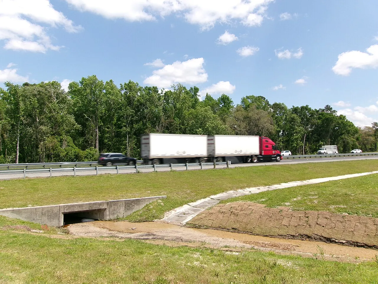 A tractor pulling two trailers eastbound on Interstate 10 in Suwannee County, Florida