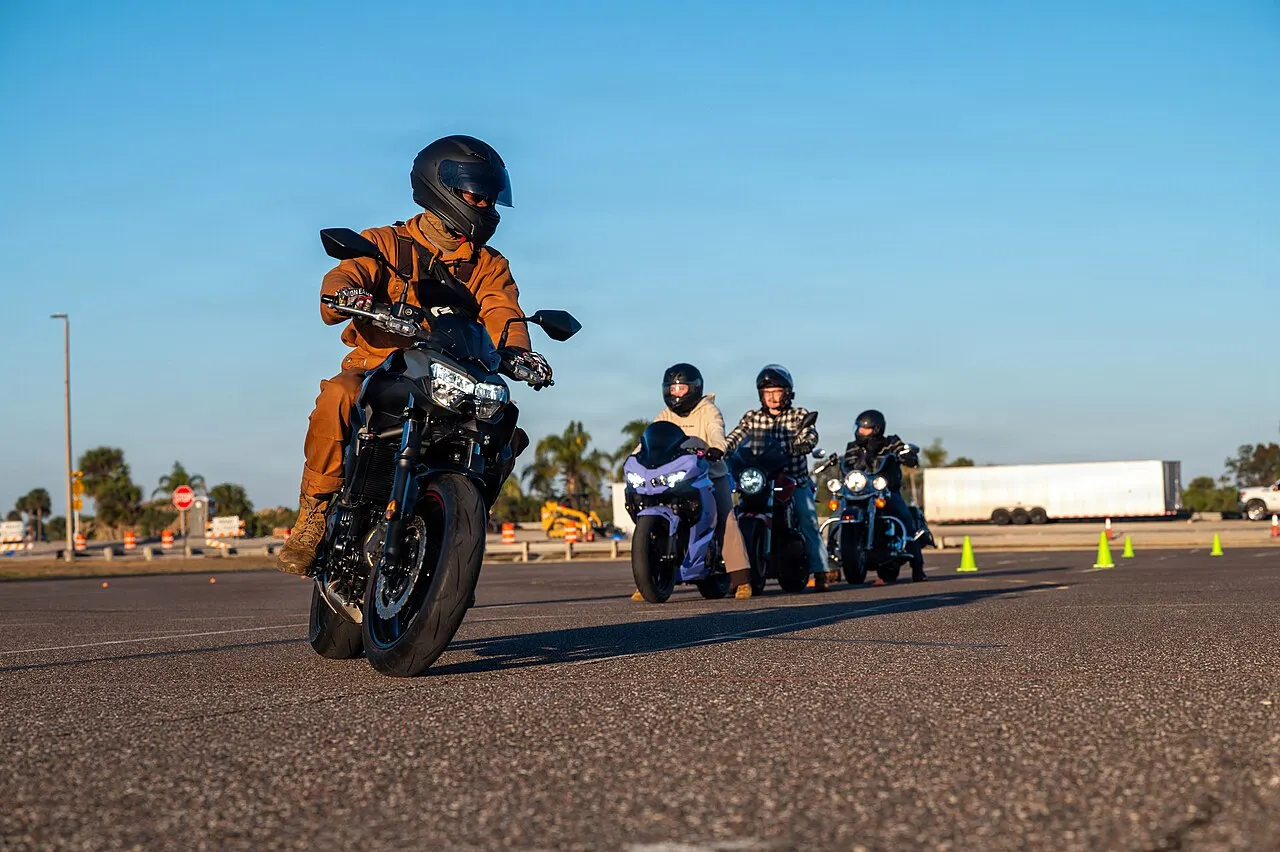 Riders on motorcycles working through a controlled exercise on a practice range at Patrick Space Force Base, Florida