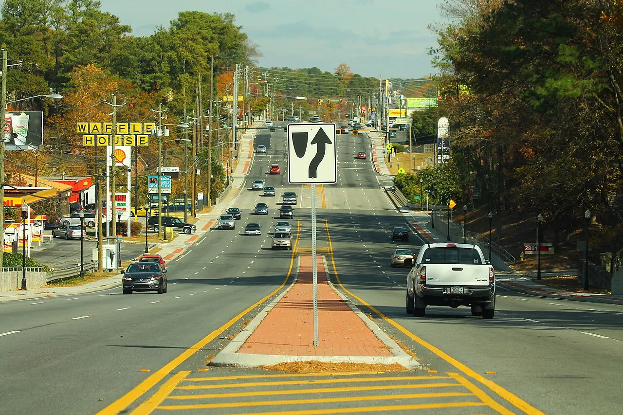 Keep Right symbol sign on the approach end of a brick median on a four-lane Georgia road