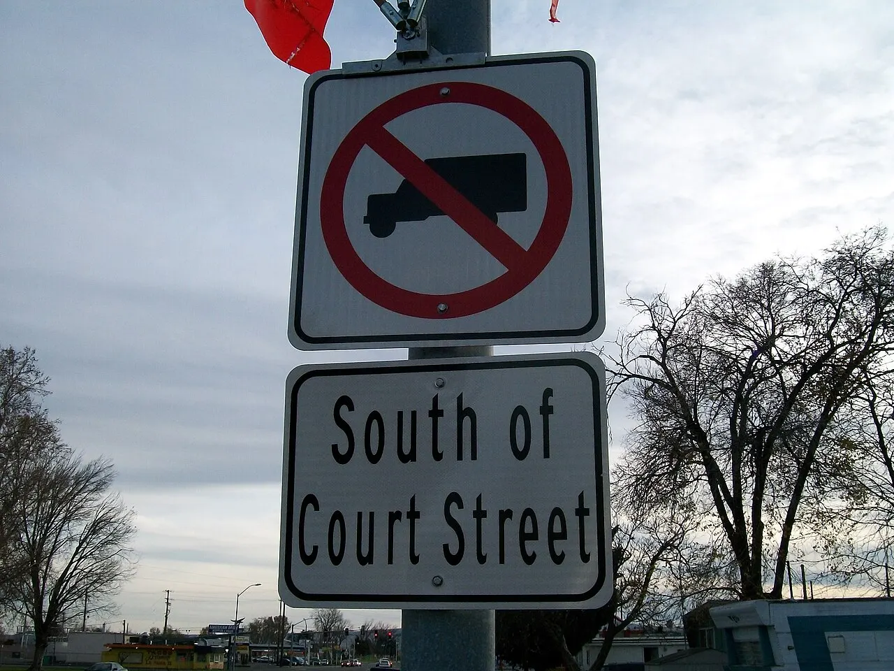 No Trucks sign, a truck symbol inside a red circle and slash, above a South of Court Street plaque