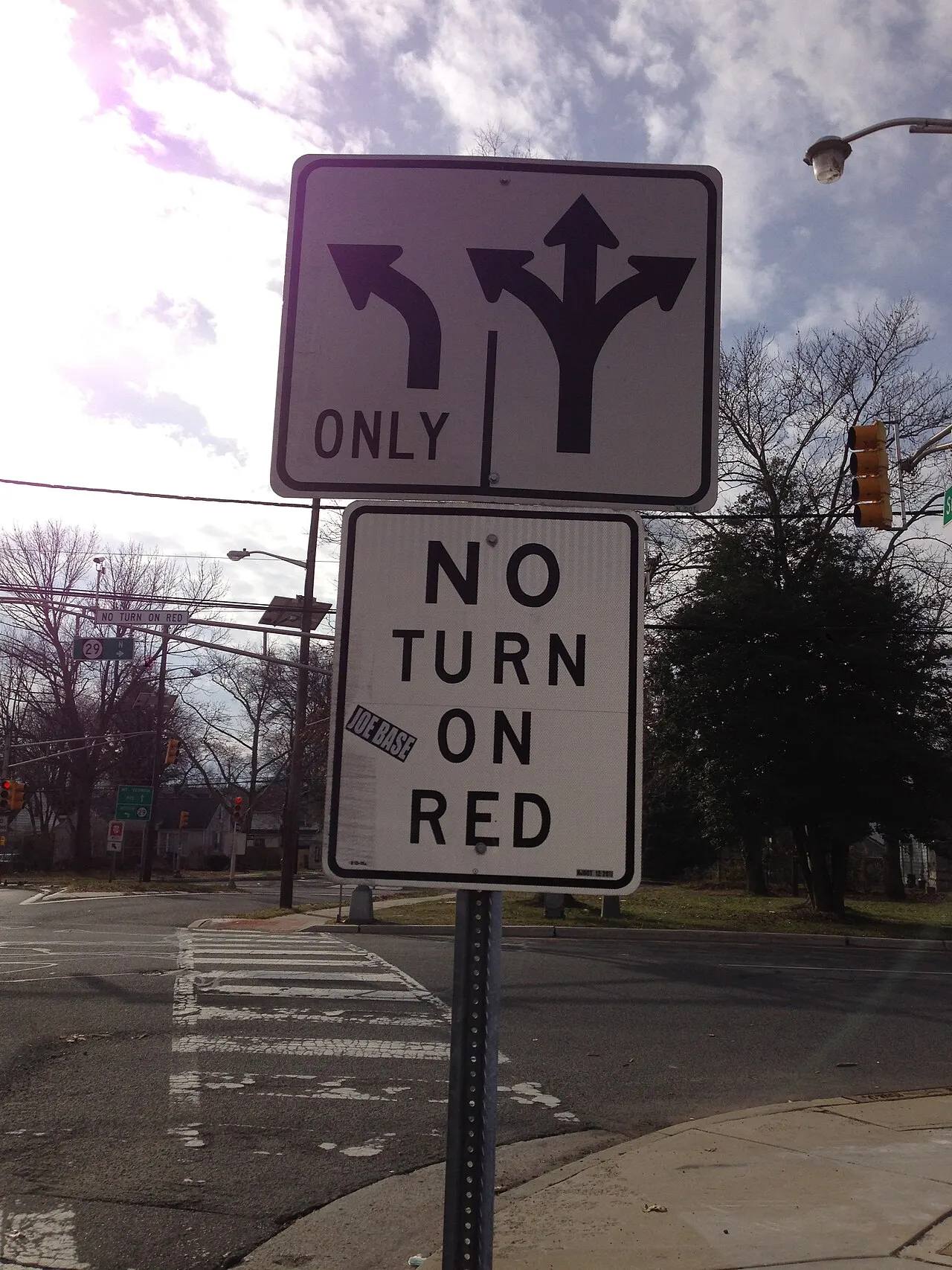 No Turn On Red sign below a lane use sign at a signalized intersection in Trenton, New Jersey