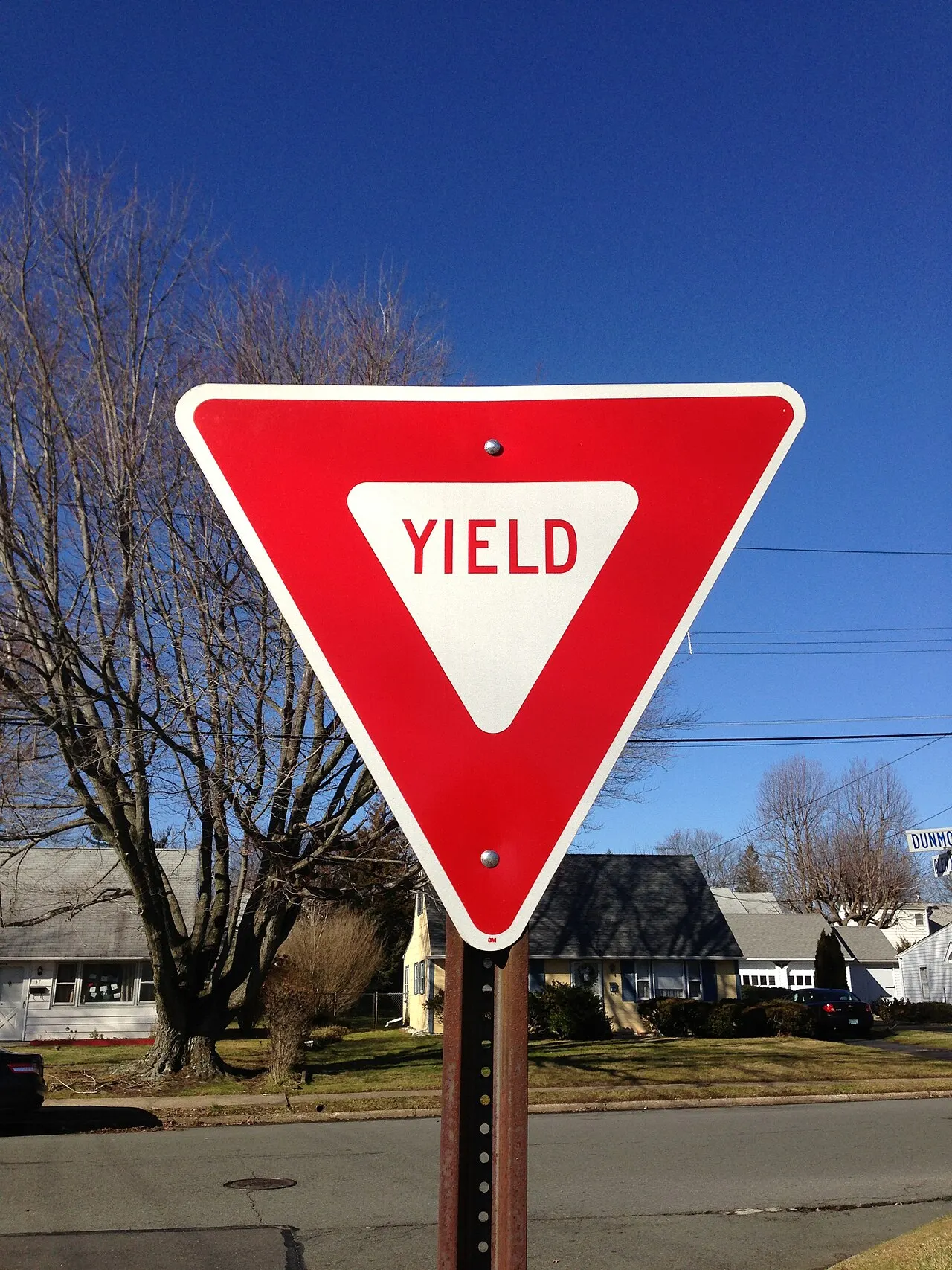 Yield sign on a post at a residential intersection in Ewing, New Jersey