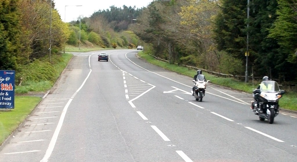 Motorcyclists riding on a UK A-road, the on-road context that the motorcycle test prepares riders for