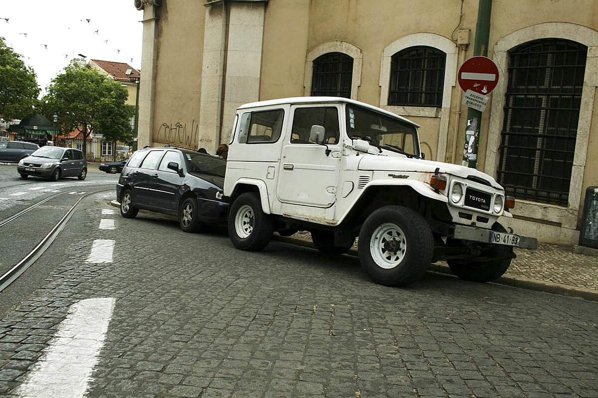 Cars parked along a UK kerbside, the on-street parking the reverse-park manoeuvre prepares you for