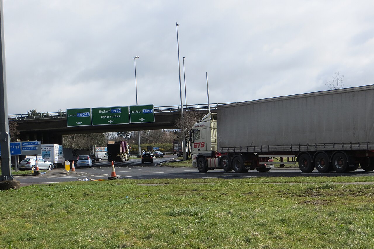 A large UK roundabout with gantry direction signs