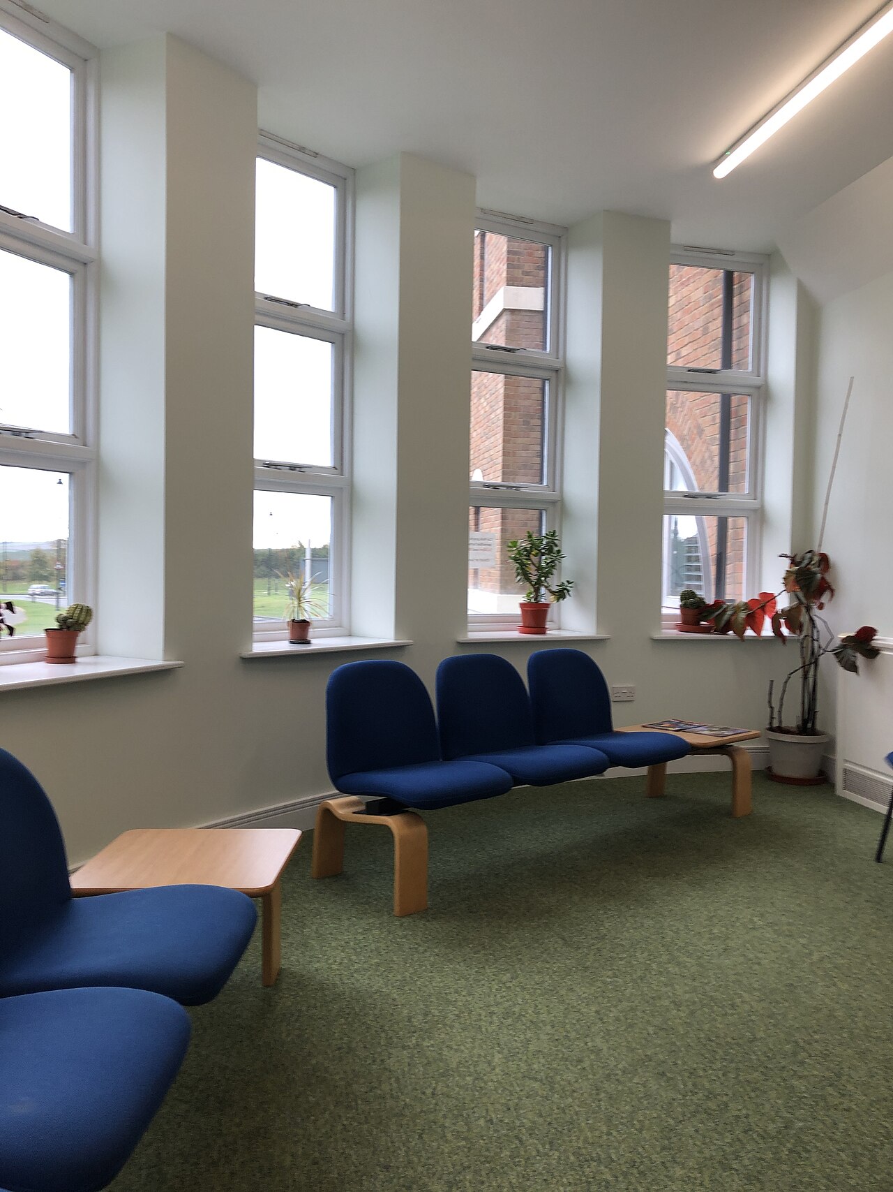 Interior of a DVSA practical driving test centre showing waiting area and reception