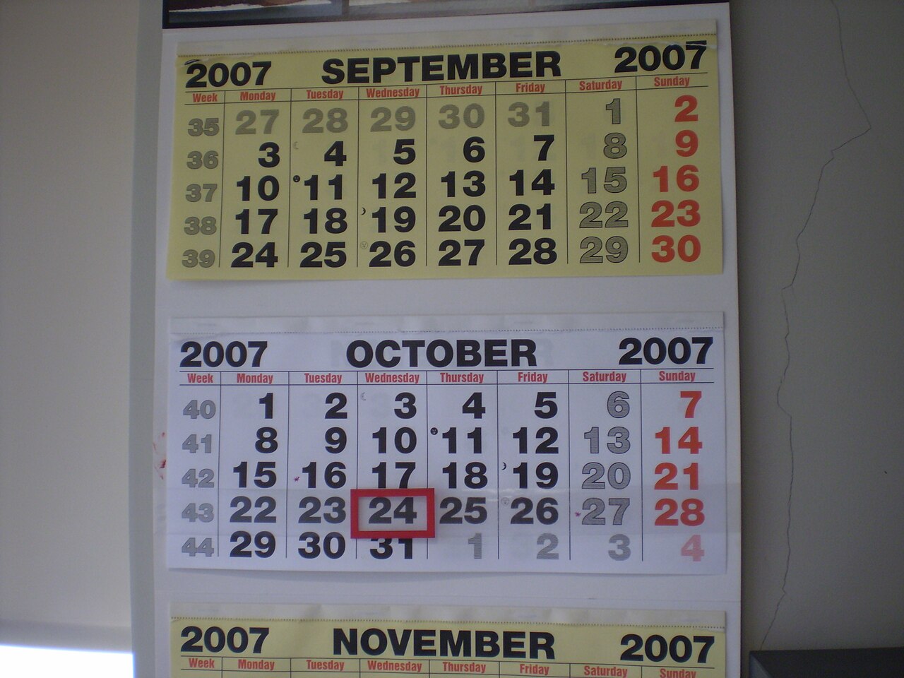 A wall calendar showing booking dates, the daily decision faced by candidates checking cancellation websites