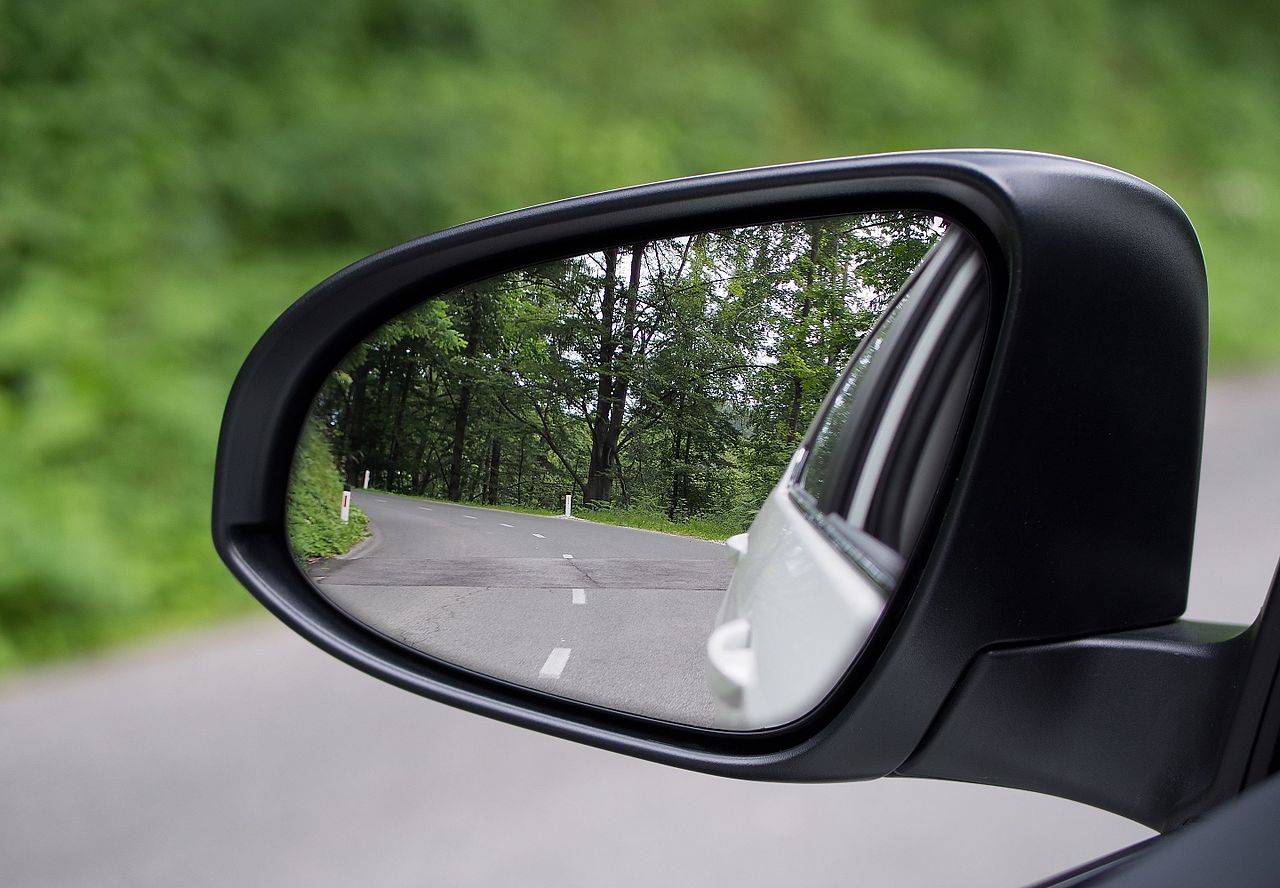 The exterior wing mirror of a car showing a residential street behind, used during MSPSL routine checks