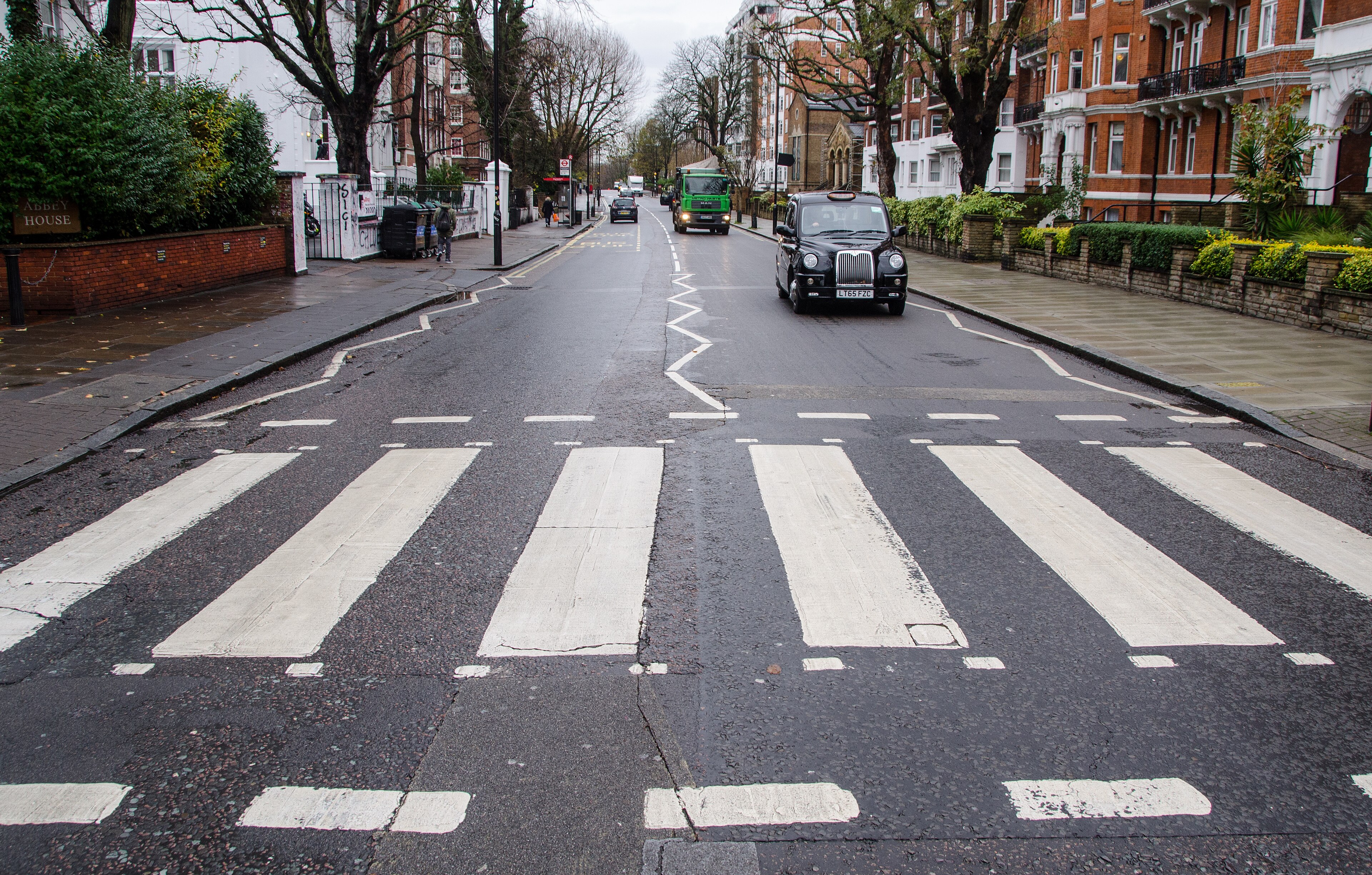 A London zebra crossing with steady pedestrian flow, typical of the conditions every London test route revisits