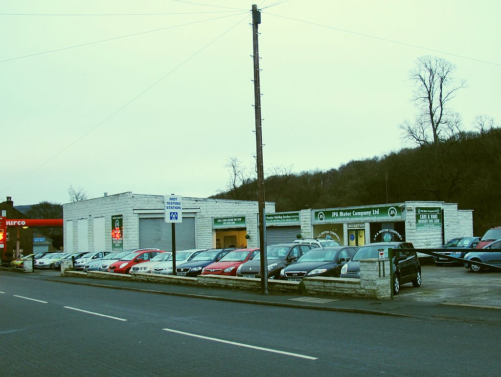 MOT testing station signage, illustrating the wider running costs that surround the headline test fee