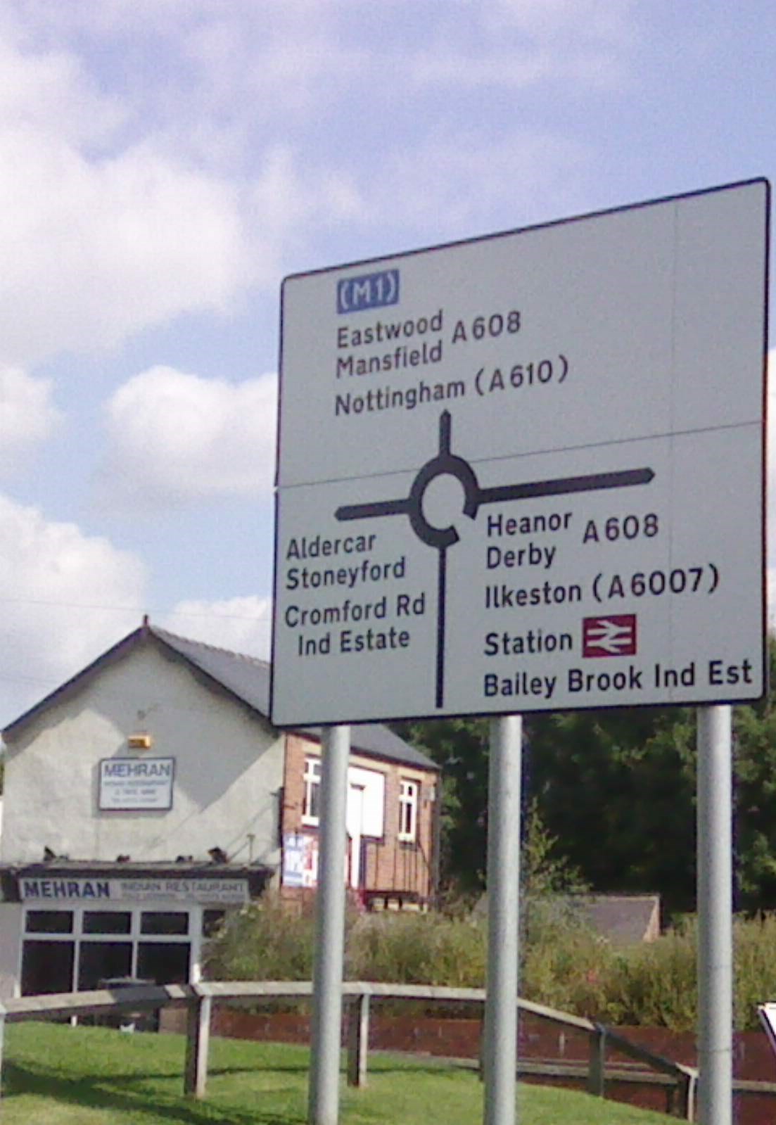 A UK roundabout sign on a complex urban junction, the kind of feature that drives route difficulty