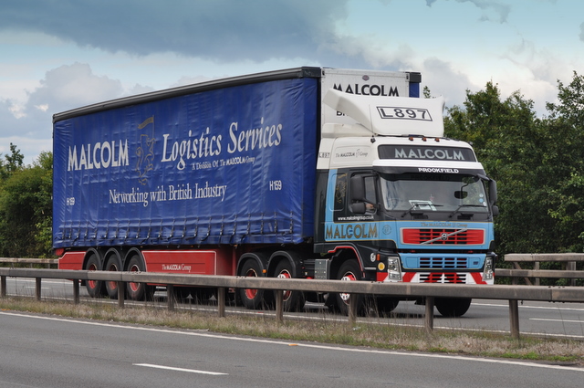 A curtain-side articulated HGV on a UK motorway