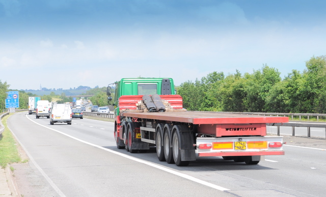 A flatbed articulated lorry on a UK motorway