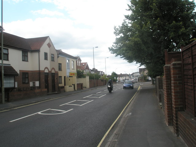 A motorcyclist riding on a UK residential street